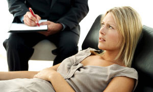 Young Woman with Her Hand on Her Belly and Man Beside Her Writing --- Image by © Royalty-Free/Corbis