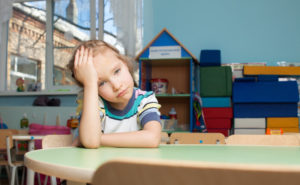 Sad child in kindergarten. Depression girl in nursery school